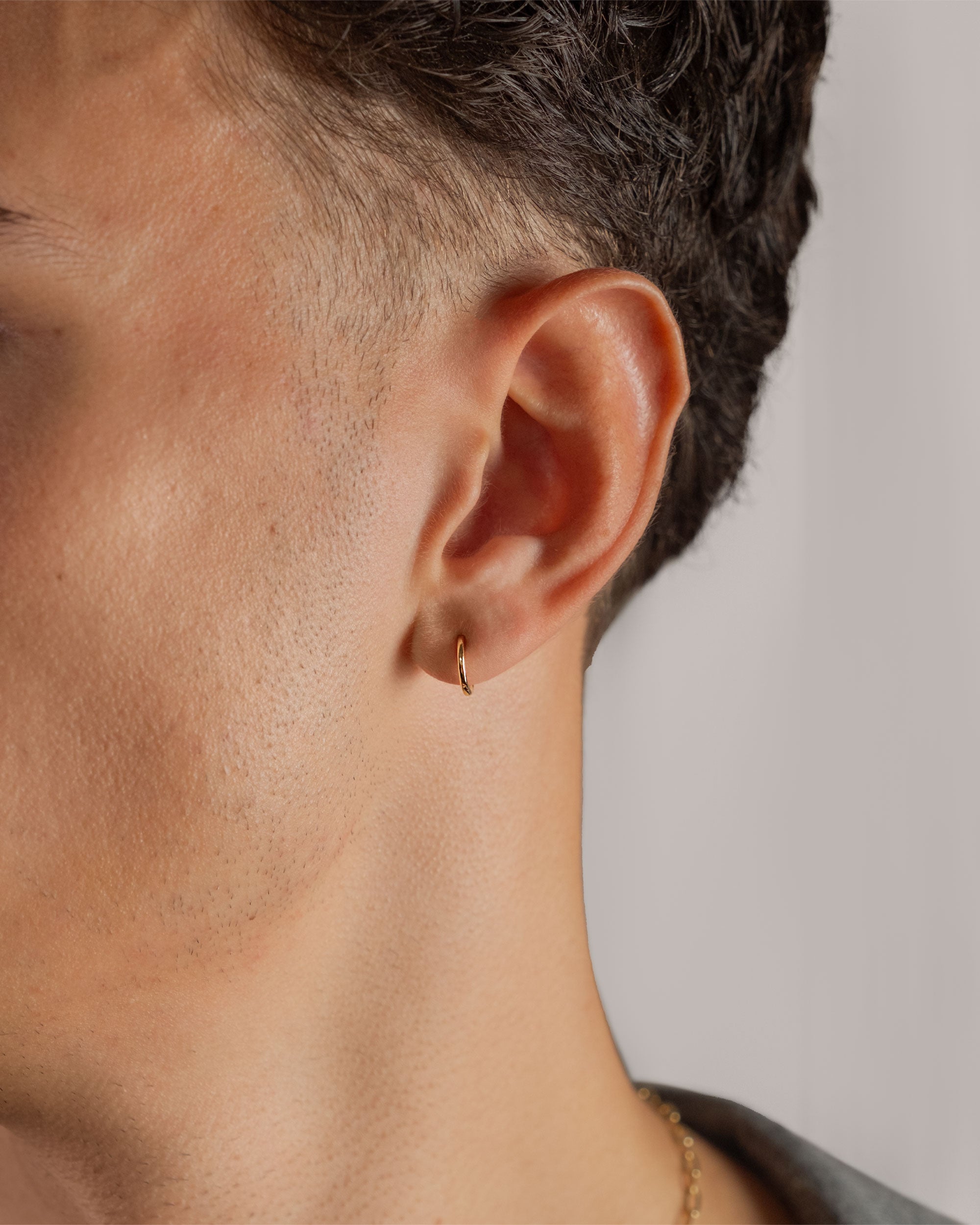 gold plated small 10mm hoop earring worn on ear – close-up – Fravour
#material_14ct Gold Plated